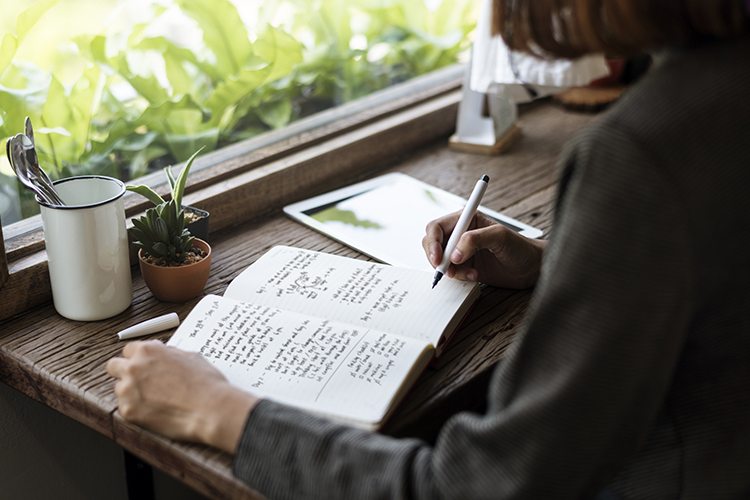 woman writing in journal